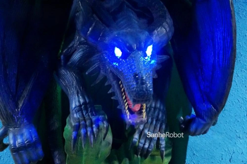 Animatronic dragon with blue LED eyes in cave environment
