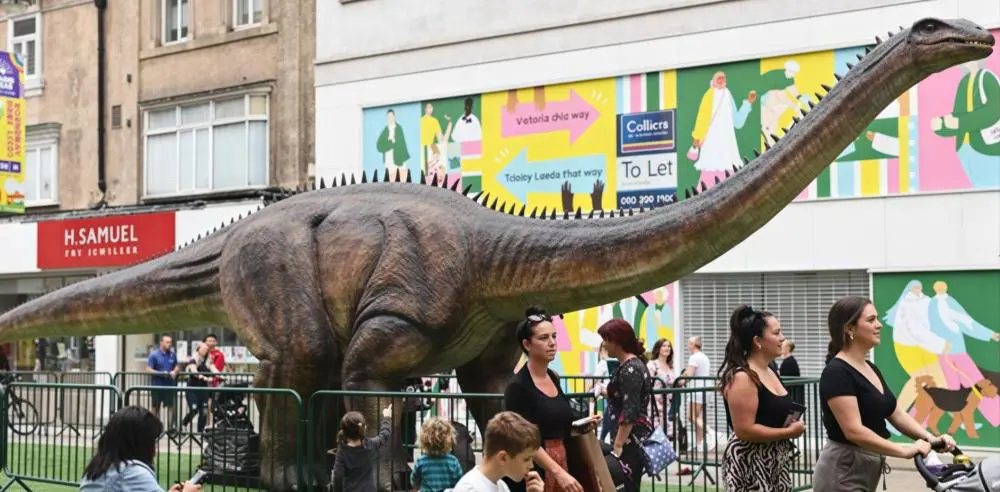 Temporary animatronic dinosaur exhibition on outdoor street at Leeds shopping centre project by Sanhe.