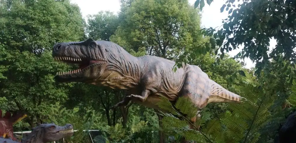 Weatherproof animatronic dinosaurs installed in an outdoor theme park environment