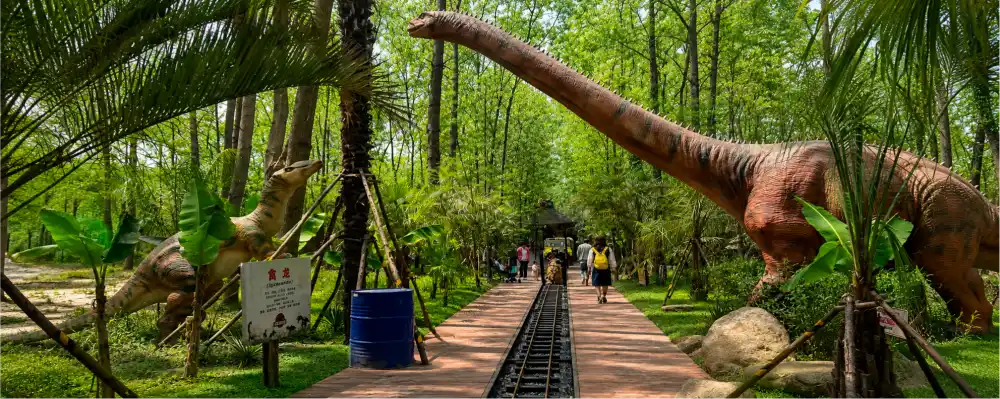 Hefei Origin Island animatronic dinosaur attraction - Long-necked dinosaurs integrated into forest with railway track